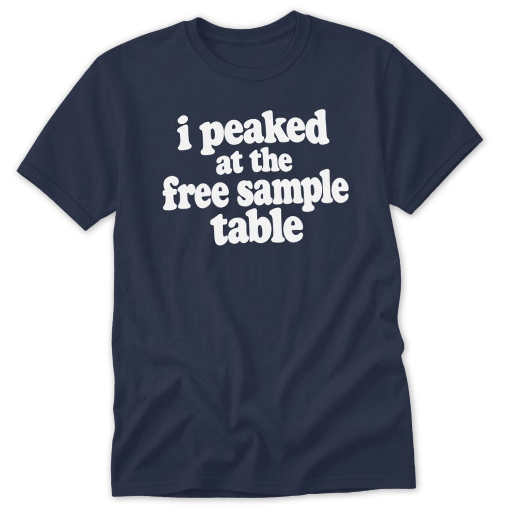 A dark blue t-shirt with white text reading "I peaked at the free sample table" centered on the chest.