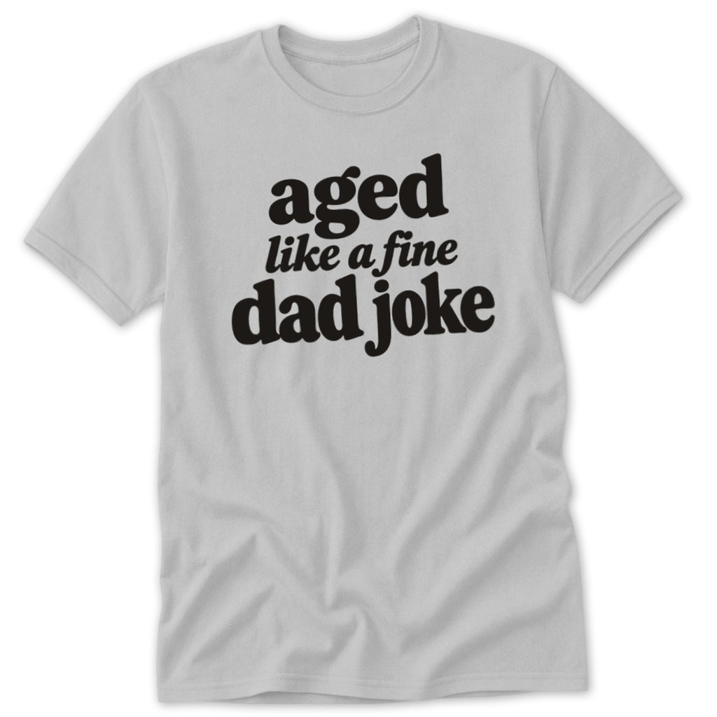 Light gray crewneck t-shirt featuring black text that reads aged like a fine dad joke