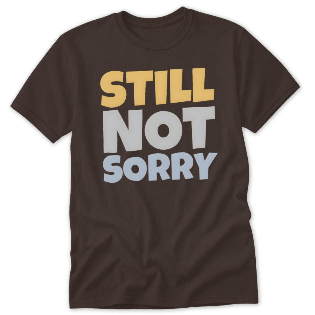 Brown short-sleeved t-shirt with the stacked text STILL NOT SORRY printed in yellow, grey, and light blue.