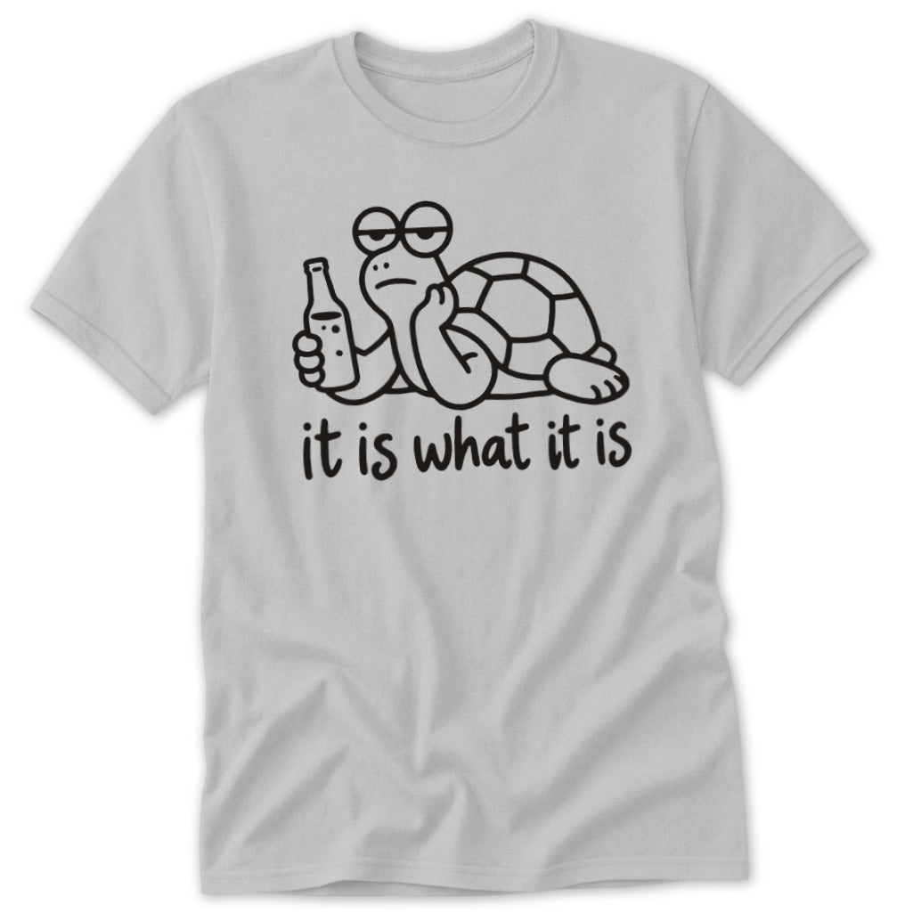 Light gray t-shirt featuring a cartoon turtle holding a bottle, with the text "it is what it is."