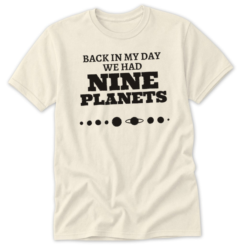 Cream t-shirt with "BACK IN MY DAY WE HAD NINE PLANETS" text and planet graphic.