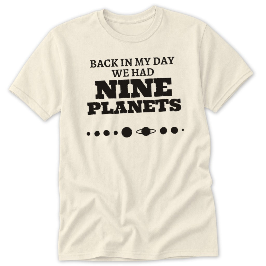 Cream t-shirt with "BACK IN MY DAY WE HAD NINE PLANETS" text and planet graphic.