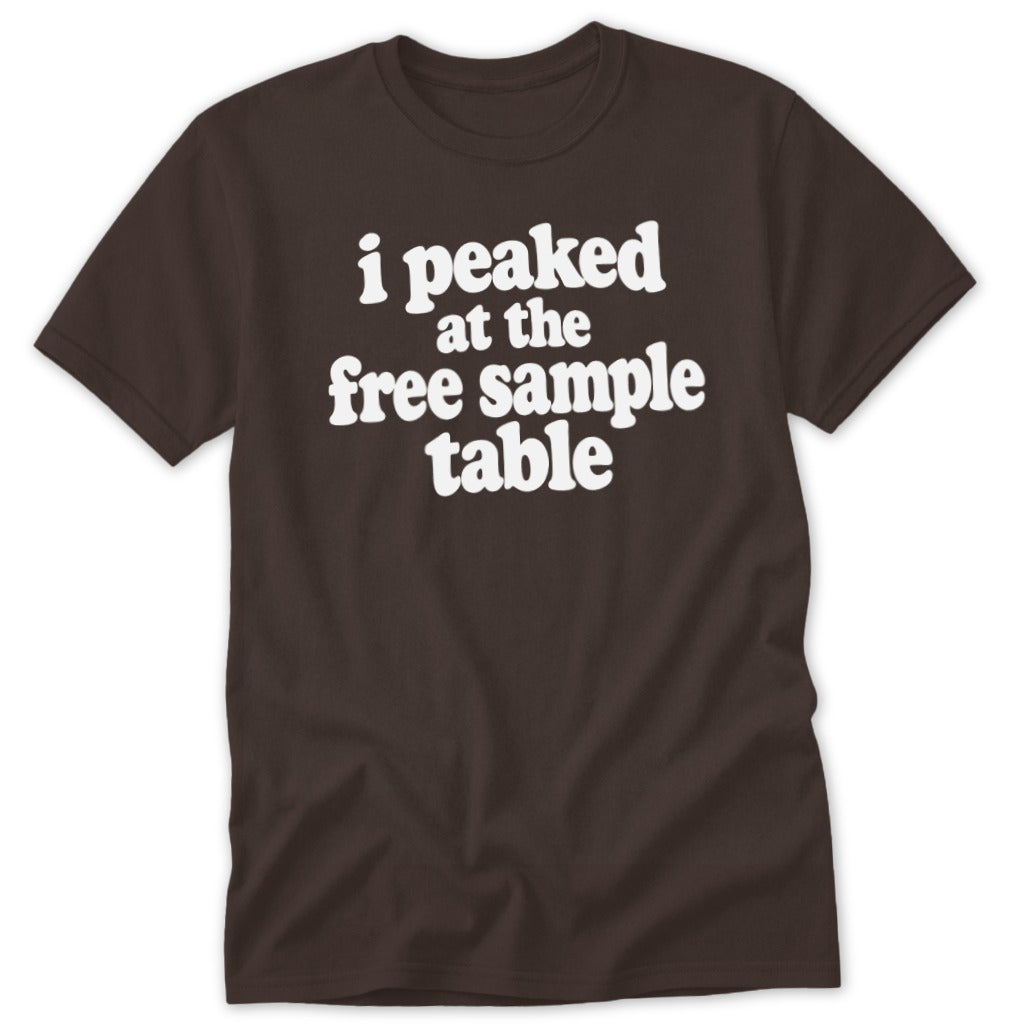 A brown t-shirt featuring the white text "I peaked at the free sample table".