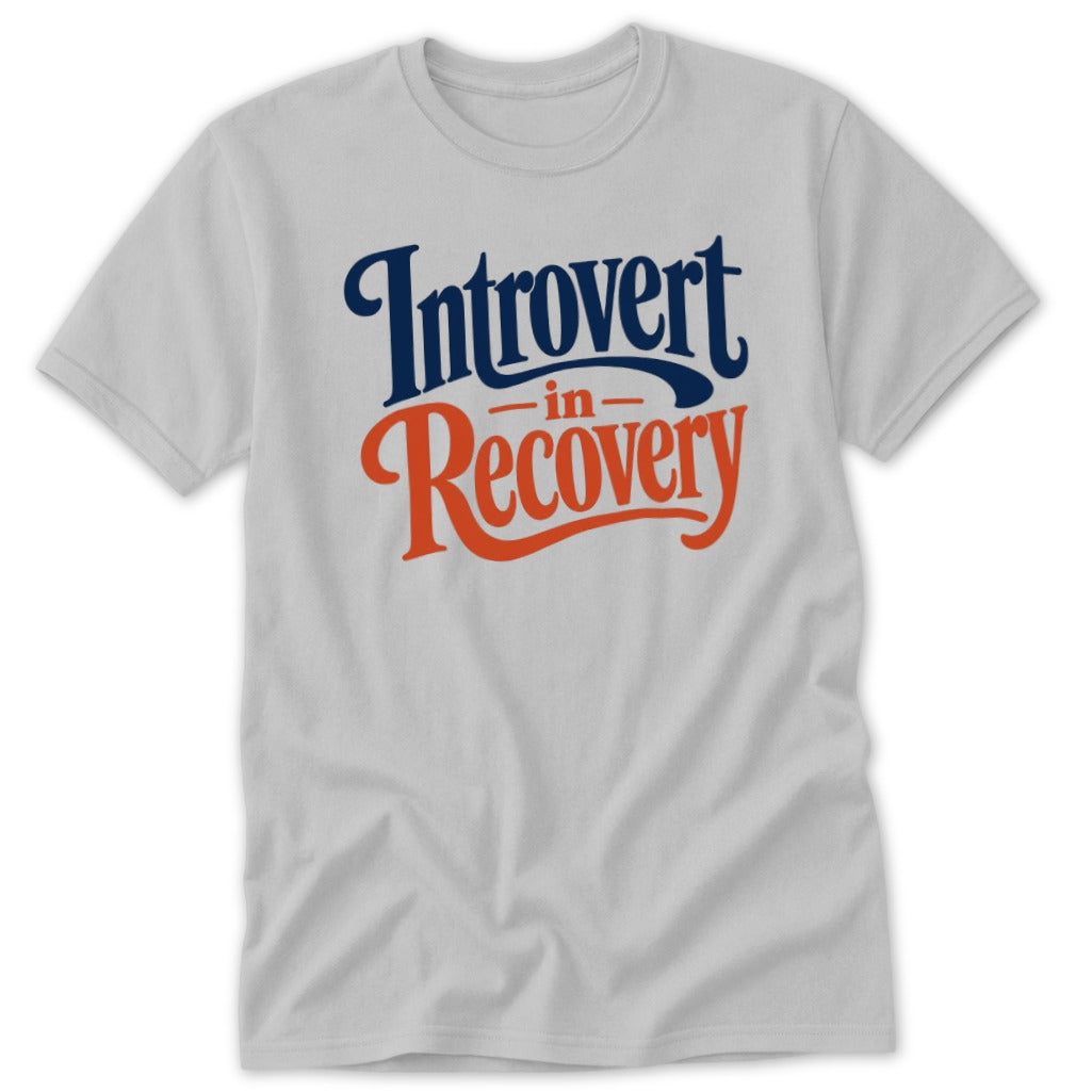A light grey t-shirt featuring the blue and orange text Introvert in Recovery.