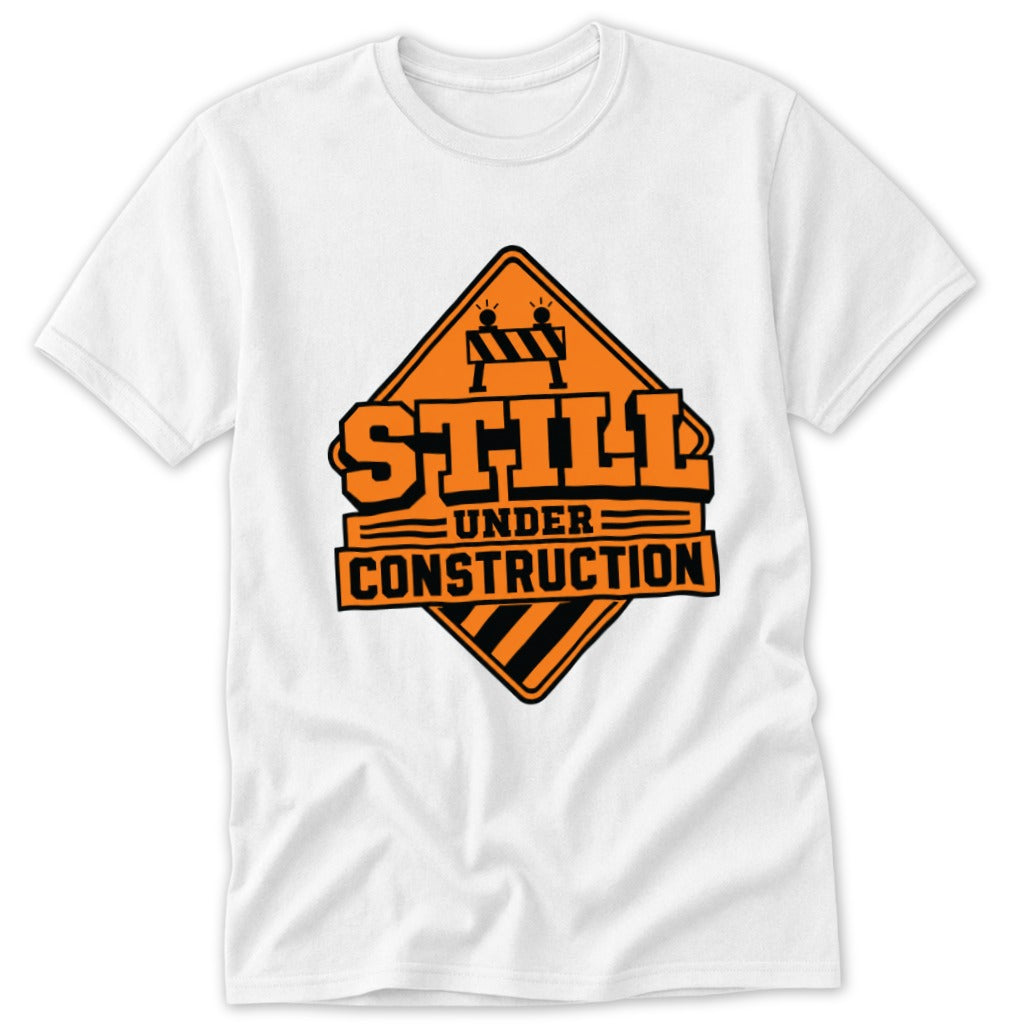 White t-shirt with orange "Still Under Construction" graphic.