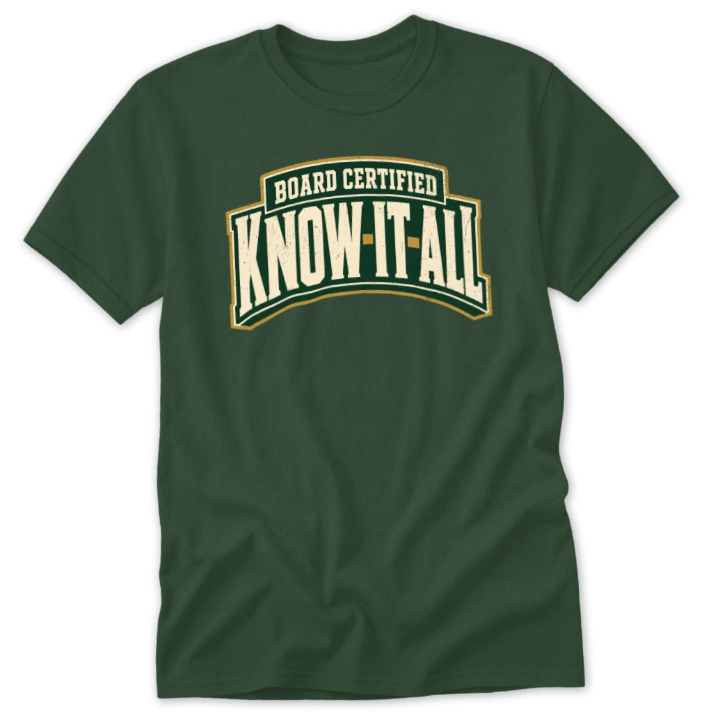 Dark green t-shirt featuring the white text "BOARD CERTIFIED KNOW-IT-ALL" arched across the chest.