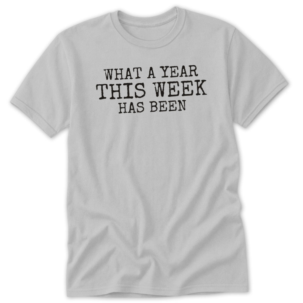 Grey t-shirt with black text "WHAT A YEAR THIS WEEK HAS BEEN".