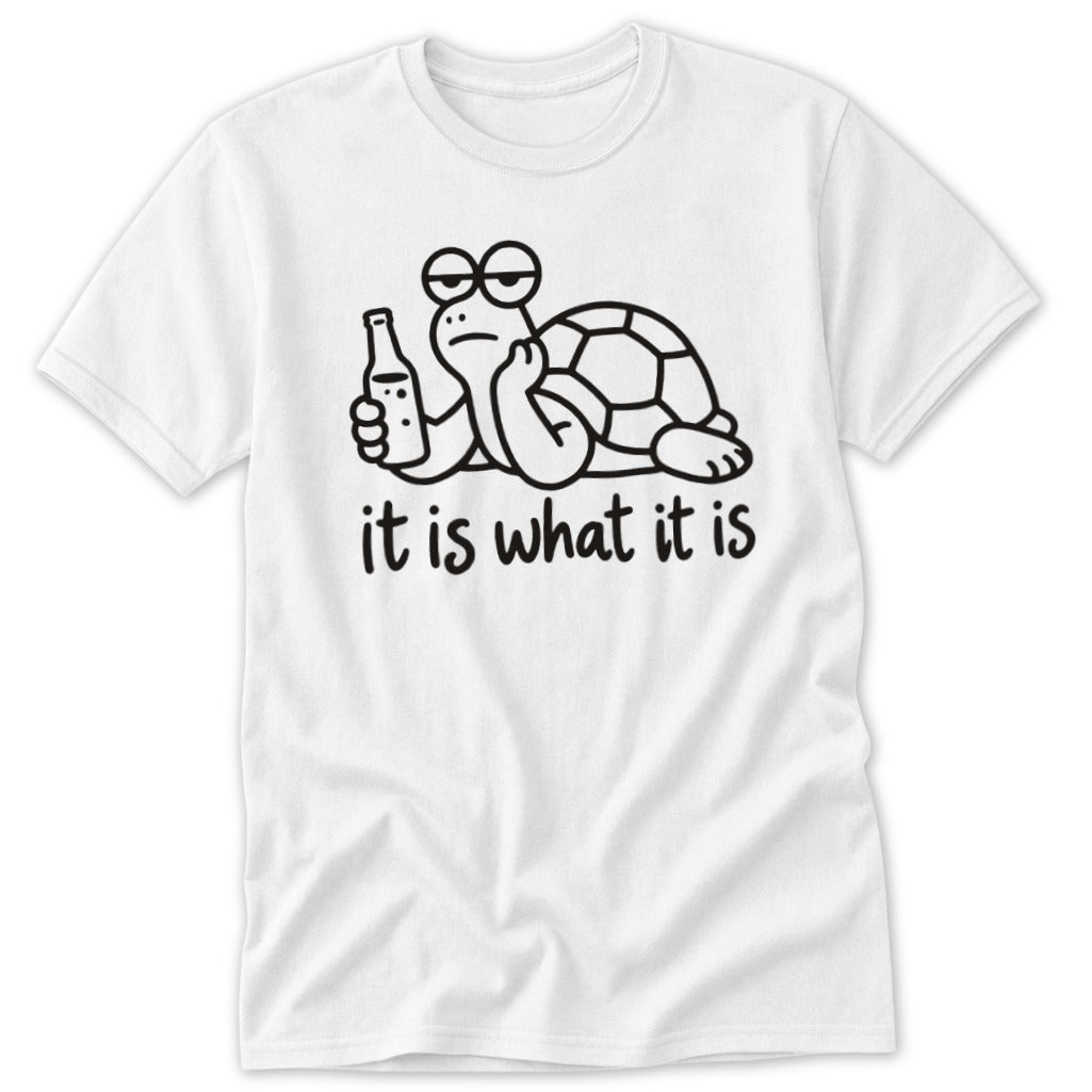 A white t-shirt featuring a cartoon turtle holding a bottle, with the text it is what it is below.