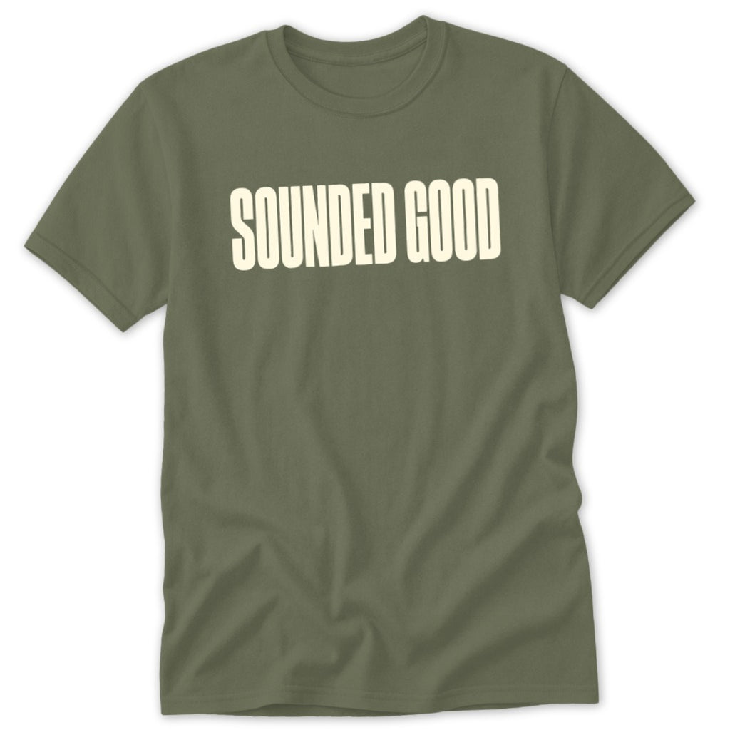 Green t-shirt with cream text reading "SOUNDED GOOD".