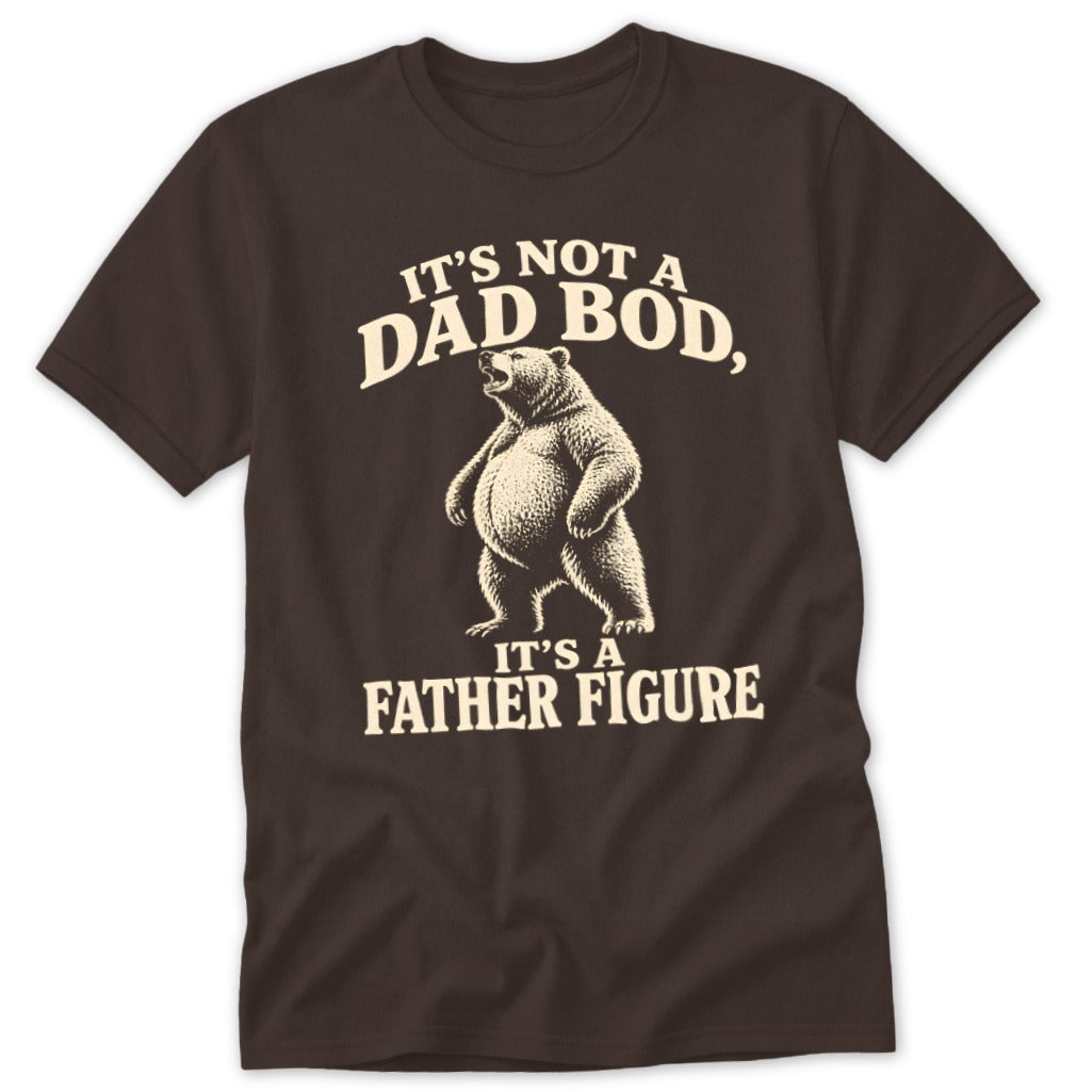 A dark brown short-sleeved t-shirt features a graphic of a standing bear with cream text reading, It is not a dad bod, it is a father figure.