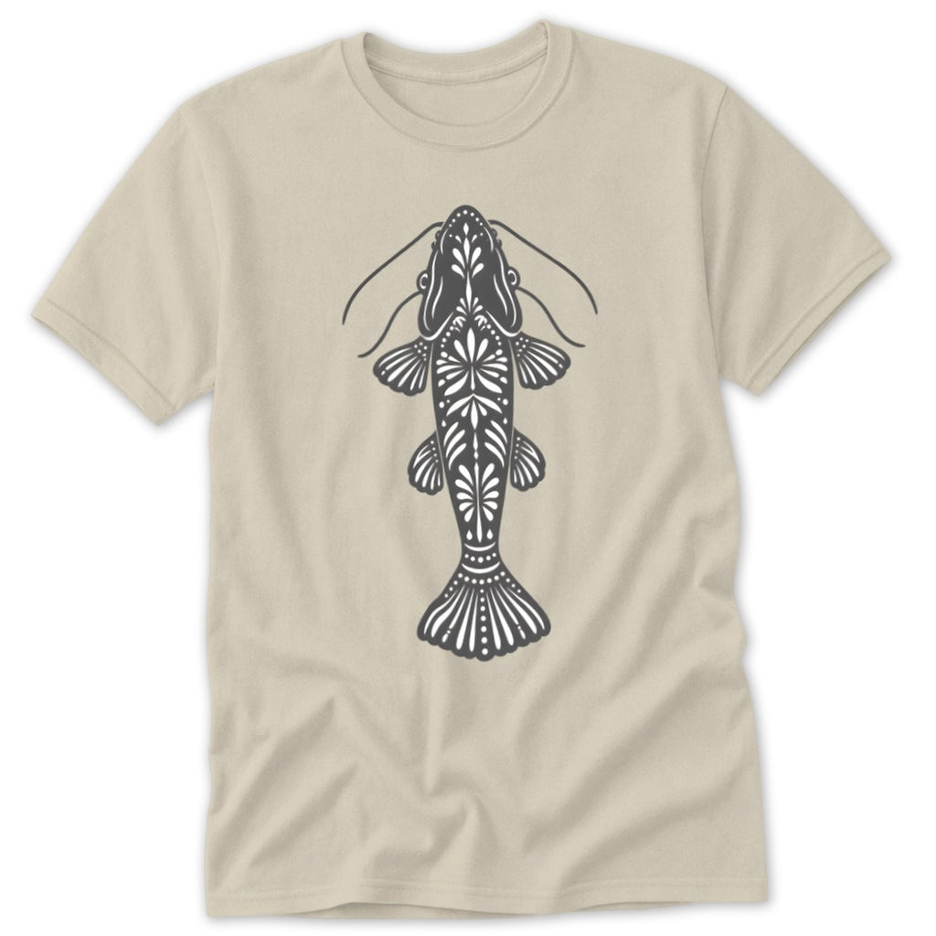 Catfish graphic with ornate patterns on a tan t-shirt.