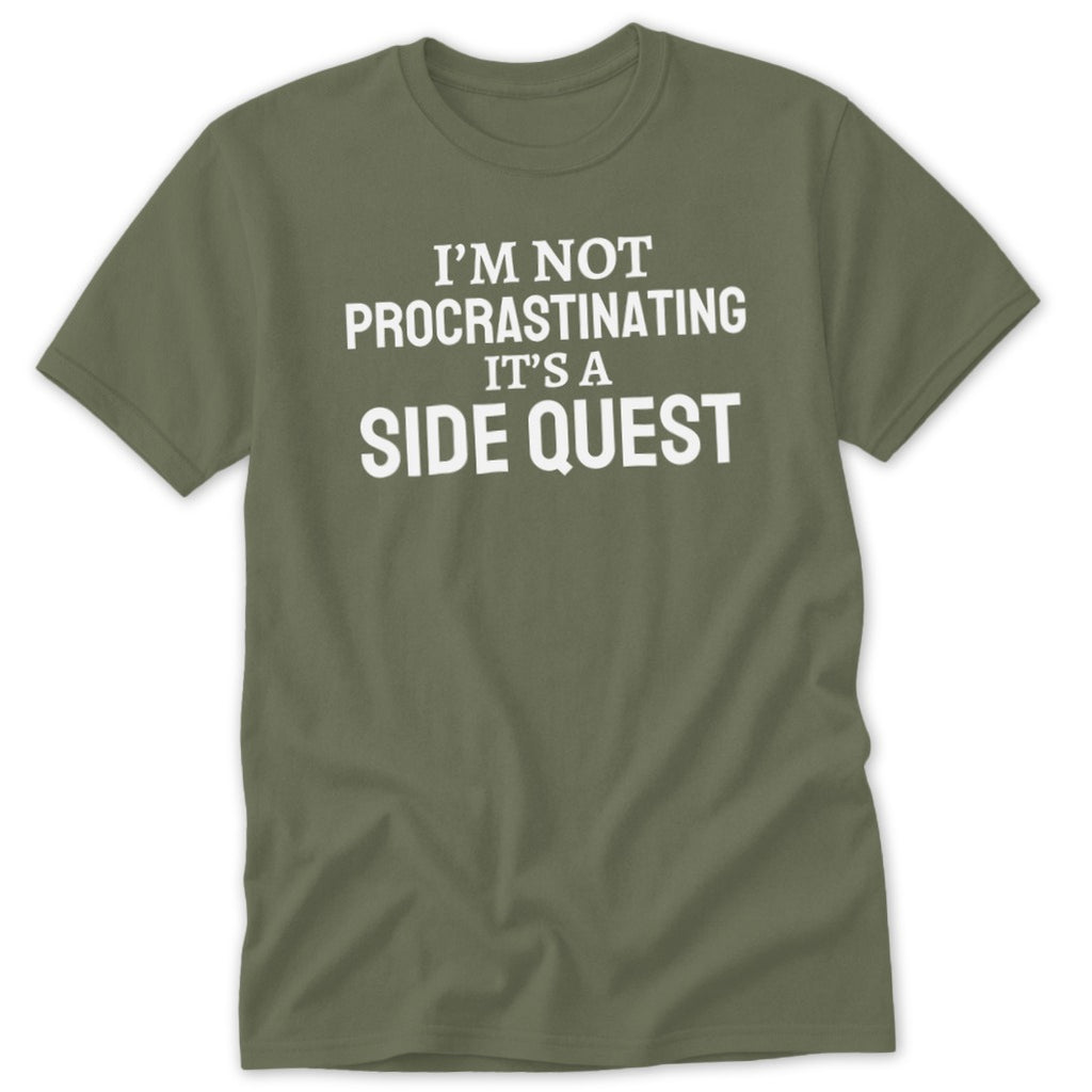Olive green t-shirt with white text "I'M NOT PROCRASTINATING IT'S A SIDE QUEST".