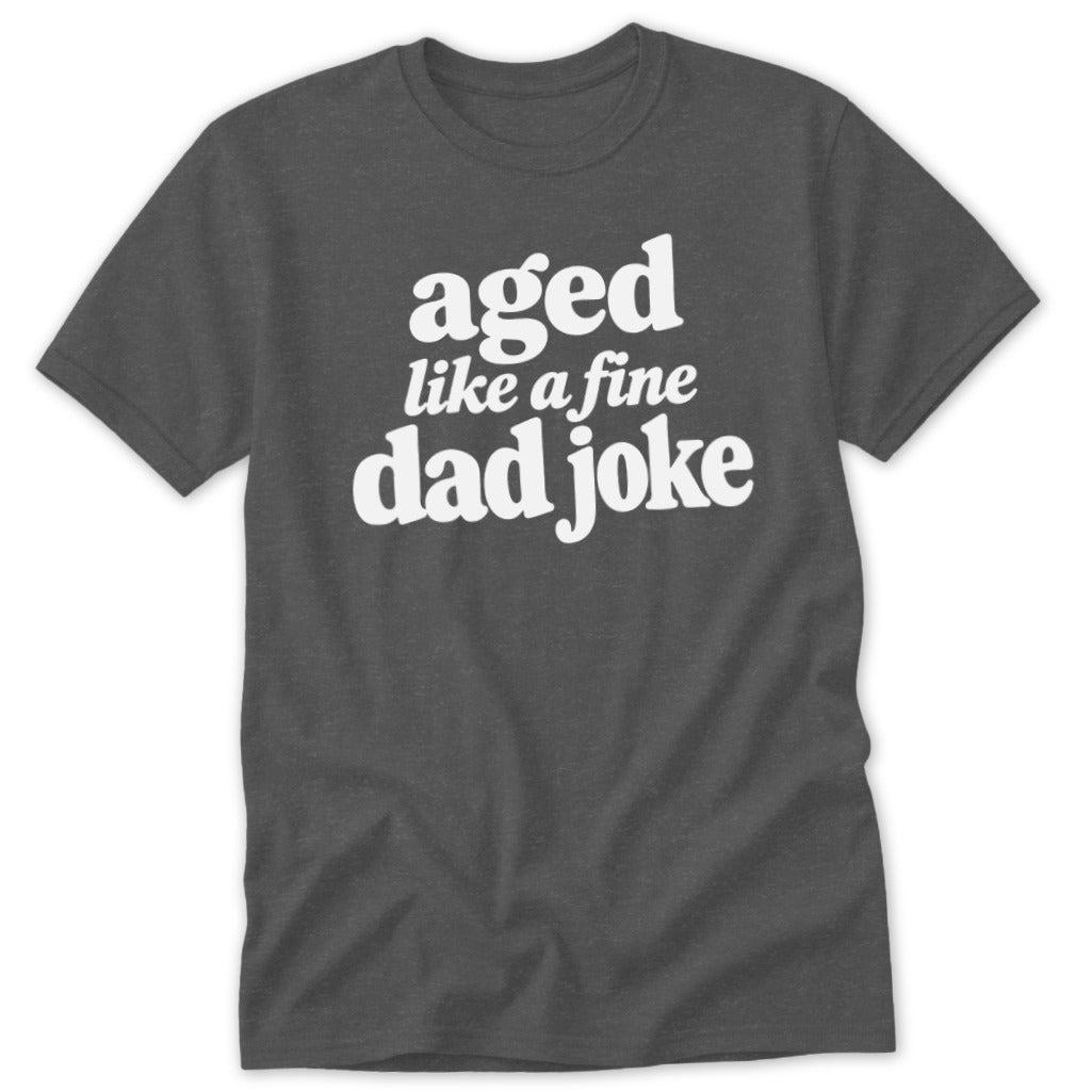 Dark gray crewneck t-shirt featuring the white text aged like a fine dad joke.