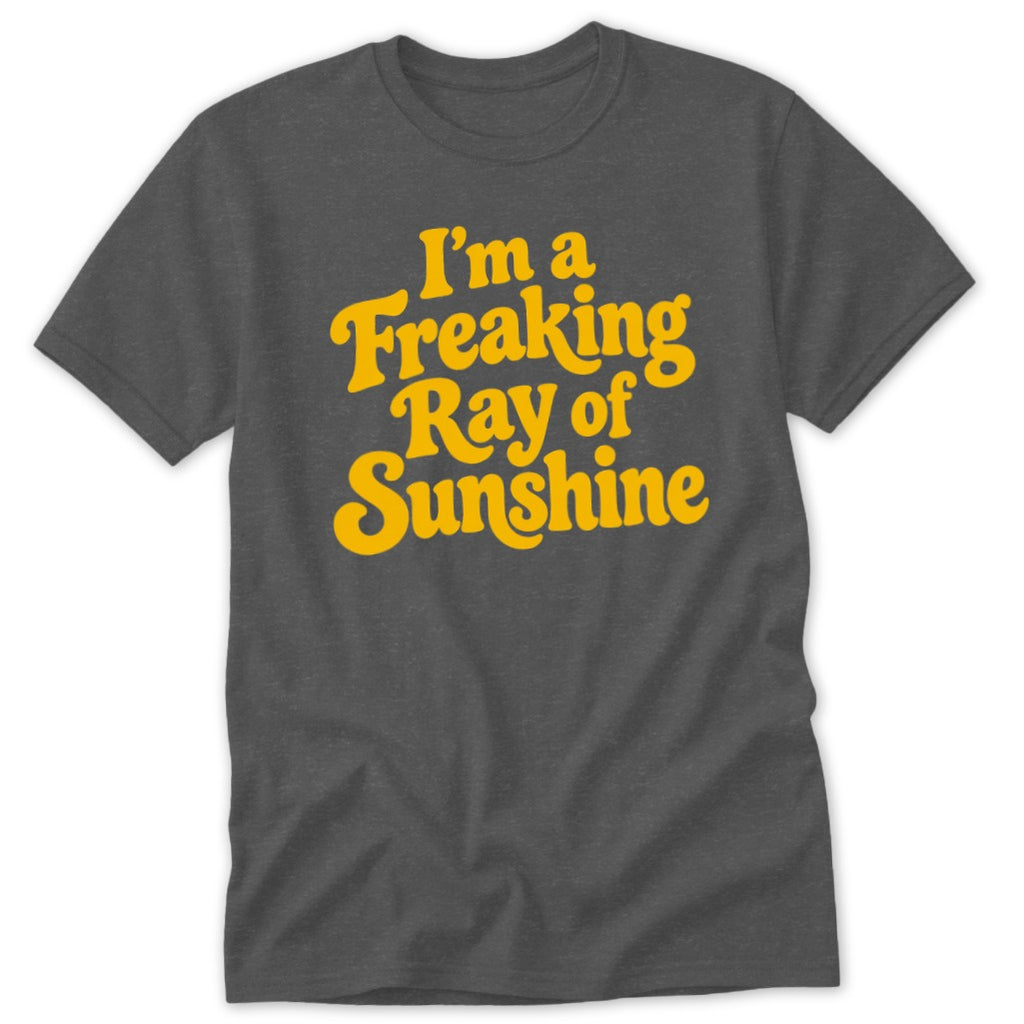 A dark gray t-shirt featuring the yellow text, I'm a Freaking Ray of Sunshine, in a groovy font.