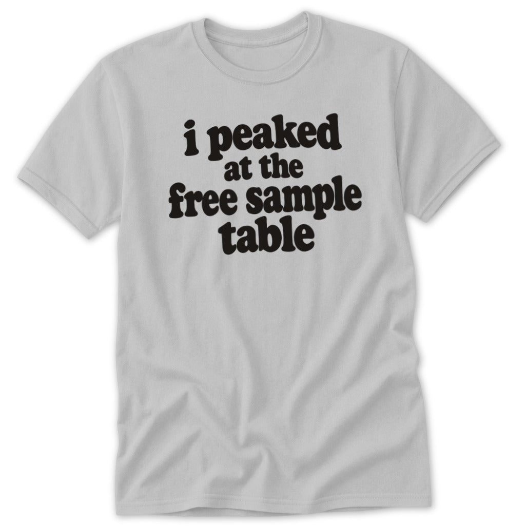 A light gray short-sleeved t-shirt featuring the black text "i peaked at the free sample table".