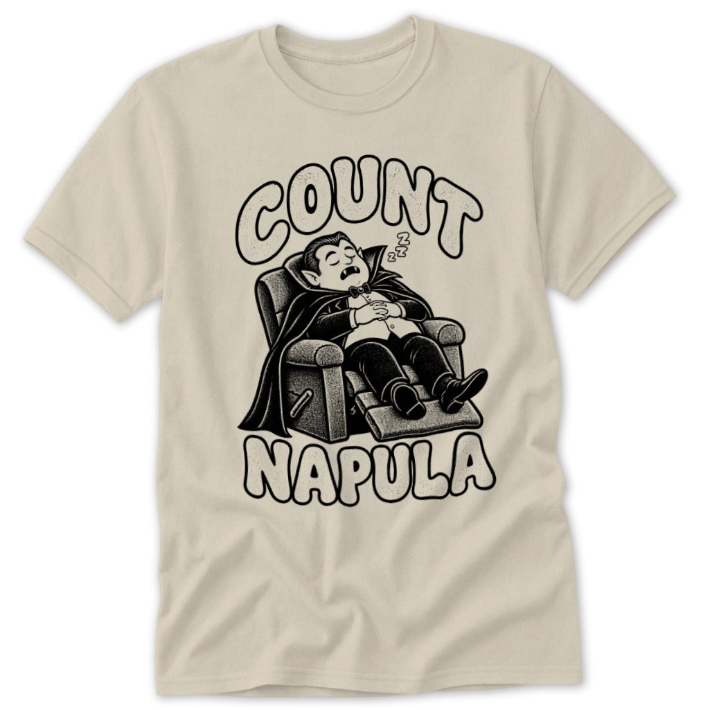 Beige t-shirt featuring a graphic of a vampire sleeping in a recliner with text reading COUNT NAPULA.
