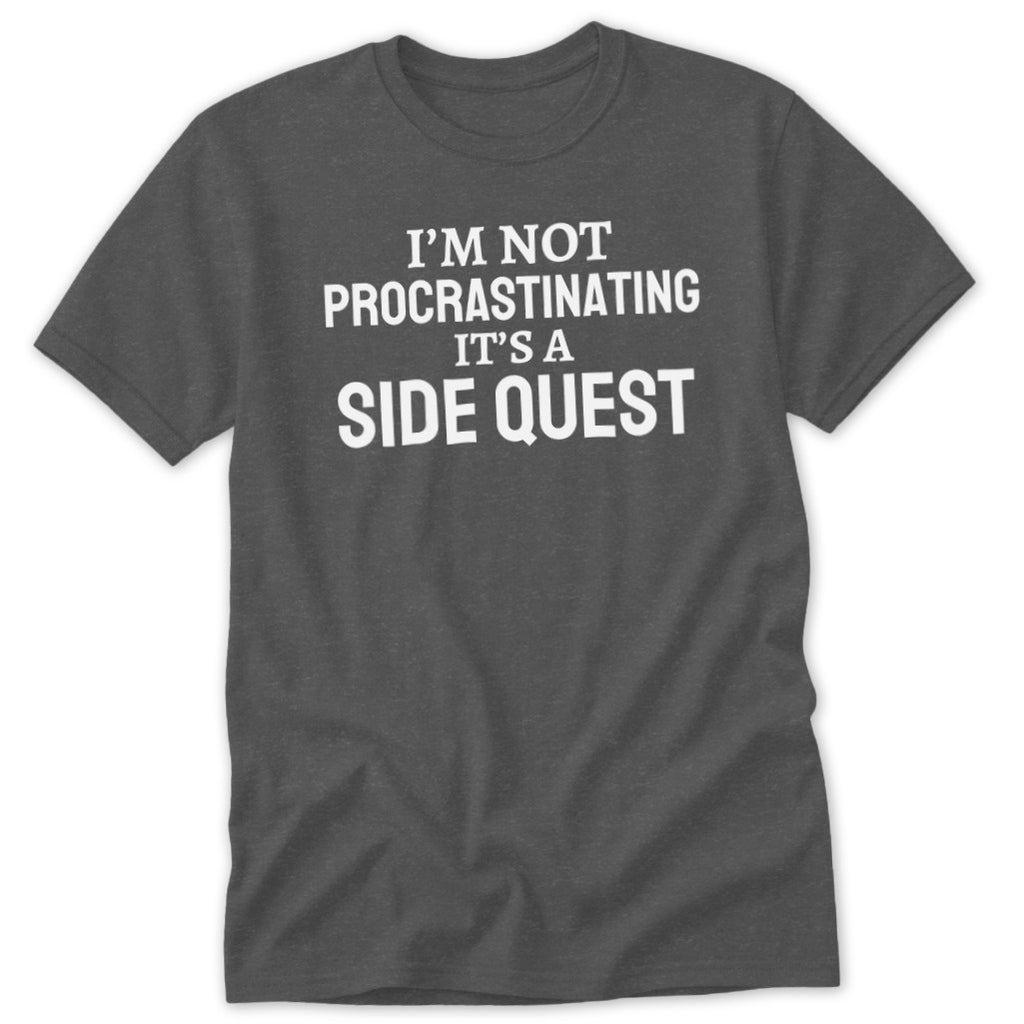 Dark grey t-shirt with white text that reads "I'M NOT PROCRASTINATING IT'S A SIDE QUEST".