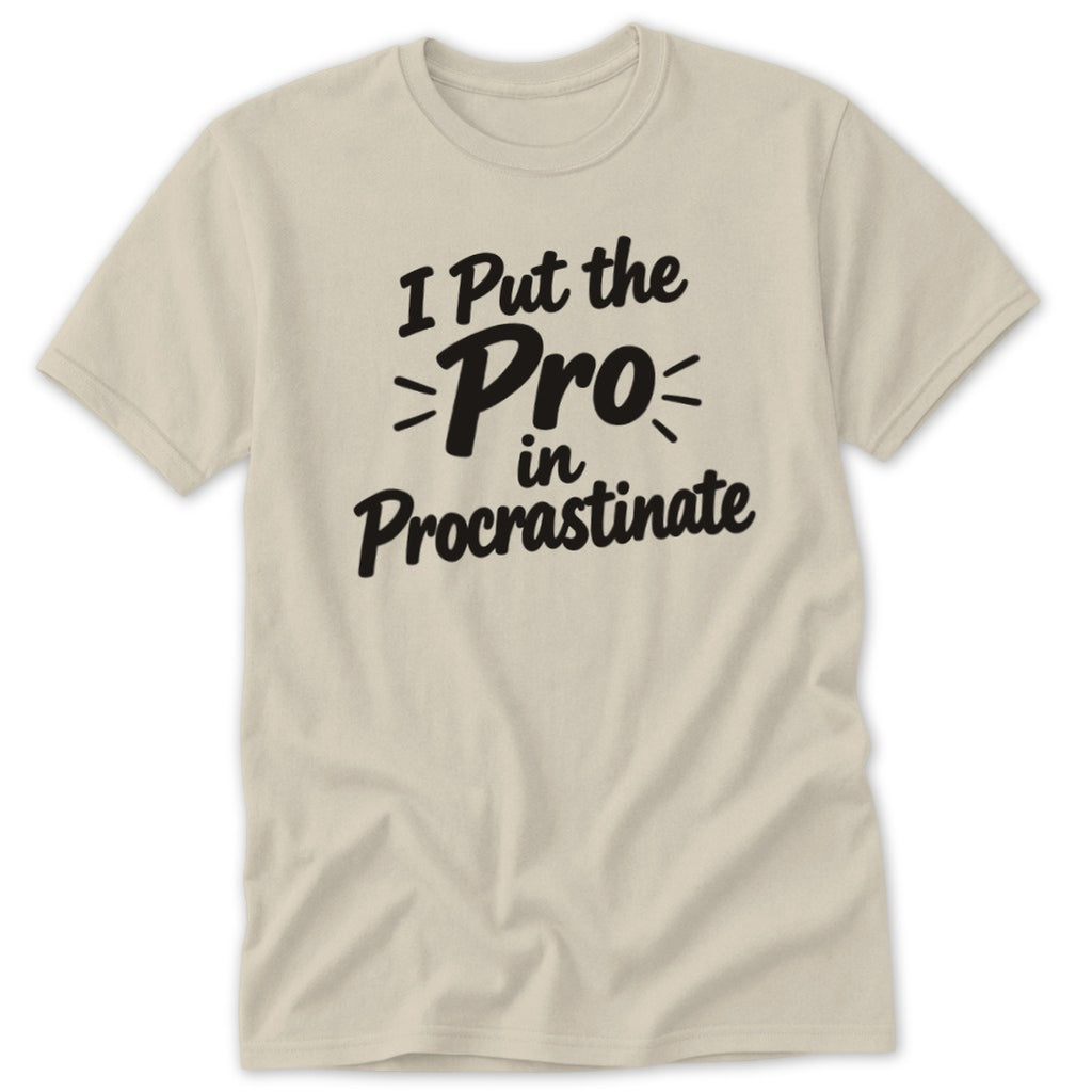 A beige crewneck t-shirt with black text that reads I Put the Pro in Procrastinate.