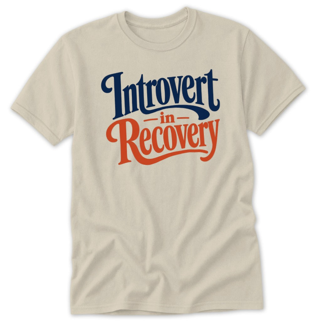 A neutral-colored short-sleeved t-shirt with blue and orange text reading Introvert in Recovery.