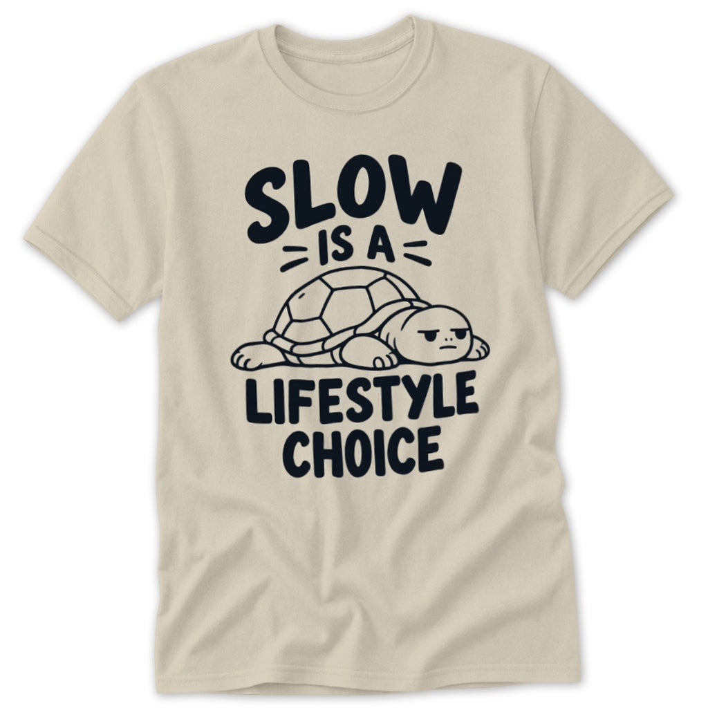 A beige short-sleeve t-shirt features a graphic of a resting turtle with text reading SLOW IS A LIFESTYLE CHOICE.