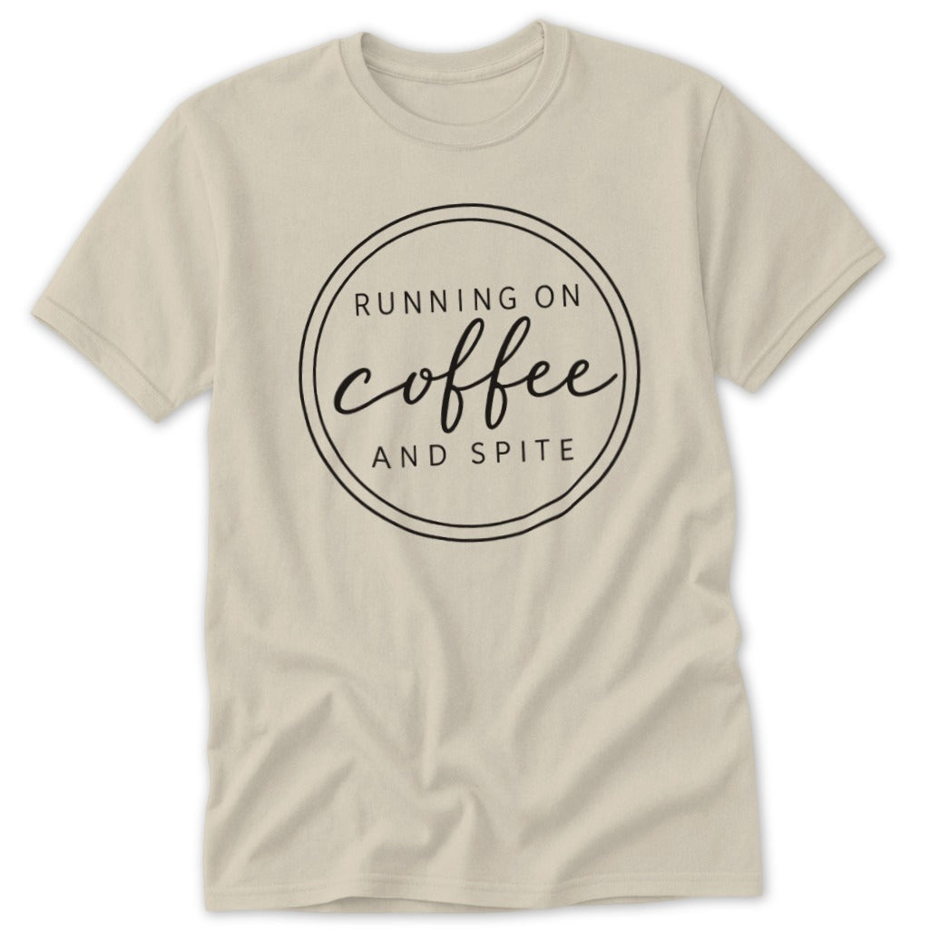 A cream-colored short-sleeved t-shirt featuring a black circular graphic with the text Running on Coffee and Spite.