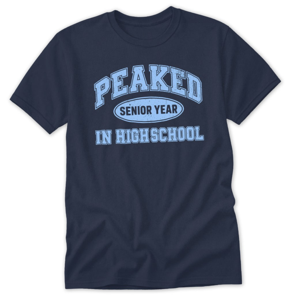 Navy t-shirt with light blue "PEAKED SENIOR YEAR IN HIGH SCHOOL" graphic.
