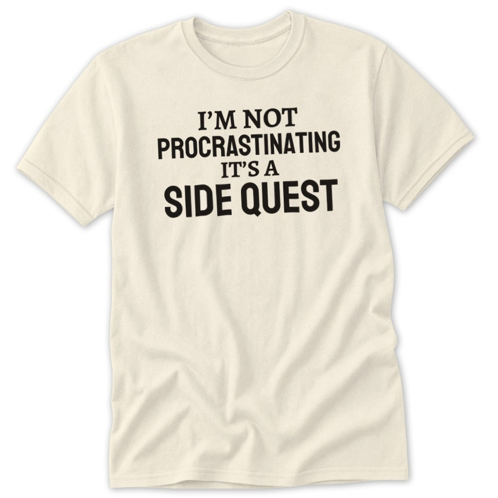 Cream t-shirt with black text reading "I'M NOT PROCRASTINATING IT'S A SIDE QUEST".
