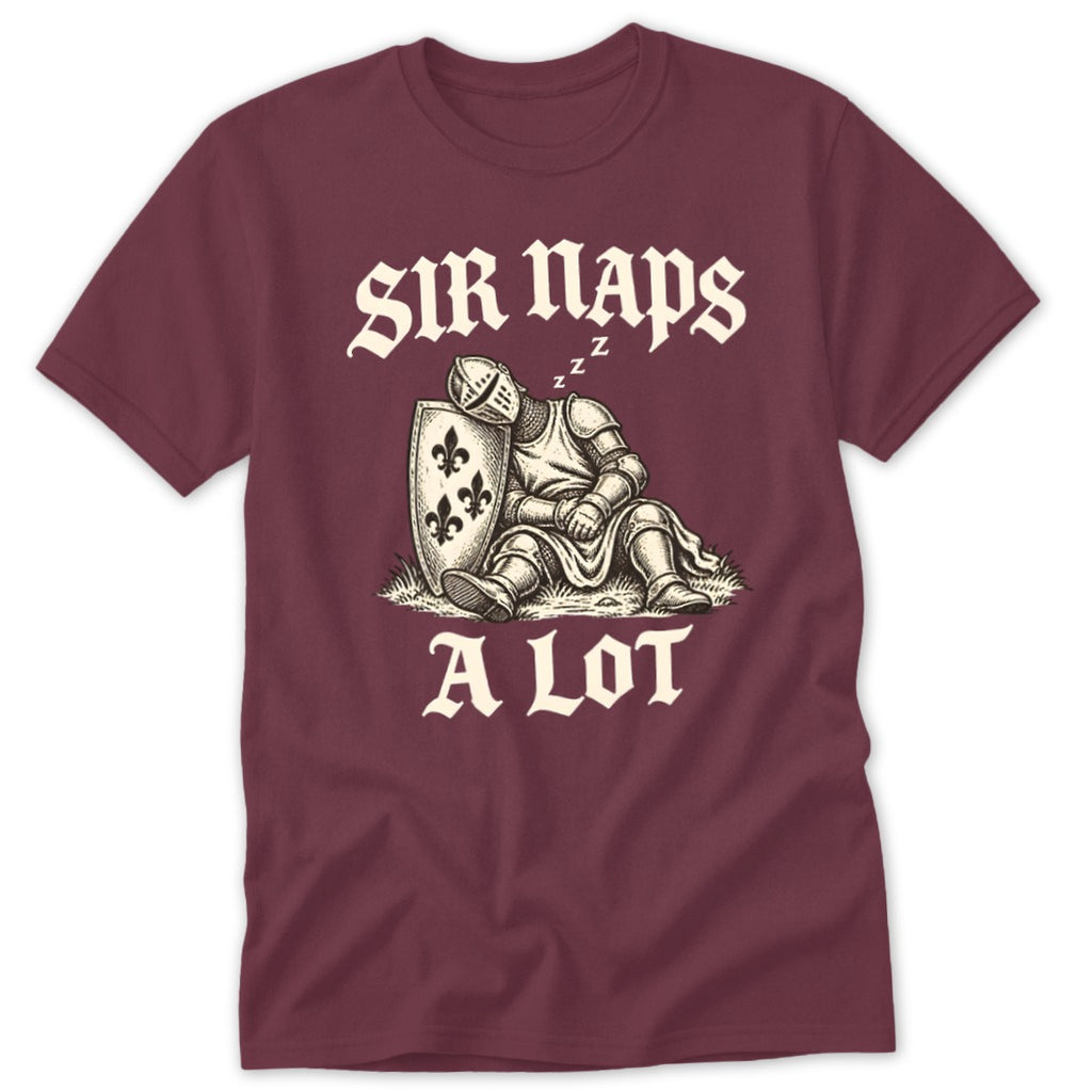 A maroon t-shirt with a vintage illustration of a sleeping knight leaning against a shield with the text SIR NAPS A LOT.