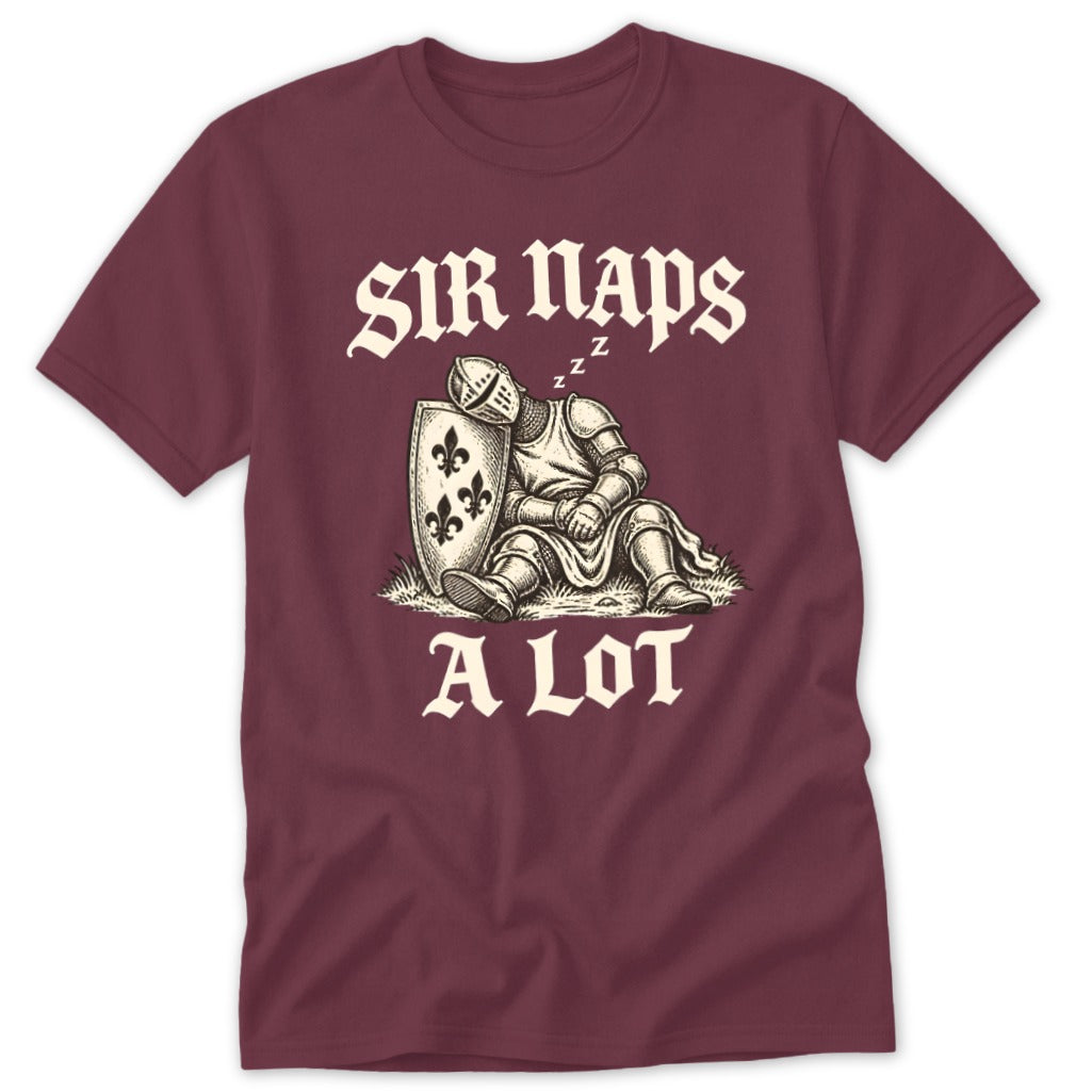 A maroon t-shirt with a vintage illustration of a sleeping knight leaning against a shield with the text SIR NAPS A LOT.