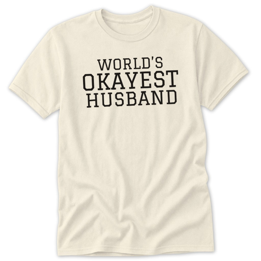 Cream t-shirt with black text reading "WORLD'S OKAYEST HUSBAND".