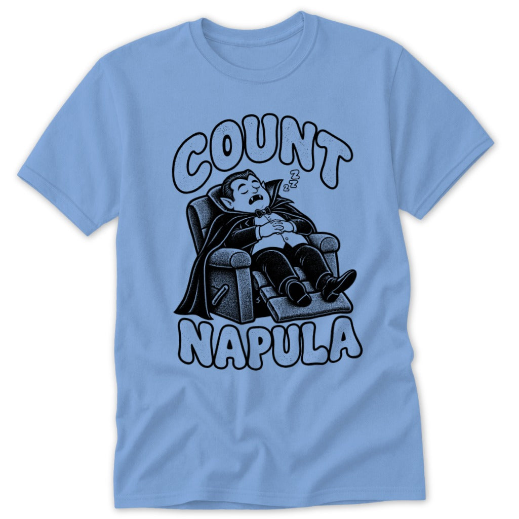 A light blue t-shirt featuring a black graphic of a vampire sleeping in a recliner with text reading Count Napula.