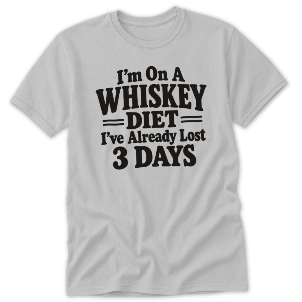 A light gray t-shirt with black text reading "I'm On A Whiskey Diet I've Already Lost 3 Days."