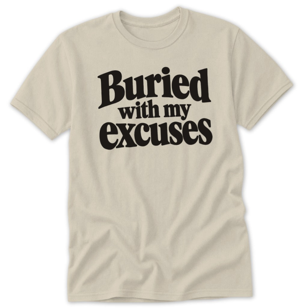 A beige short-sleeve t-shirt with black text that reads Buried with my excuses.