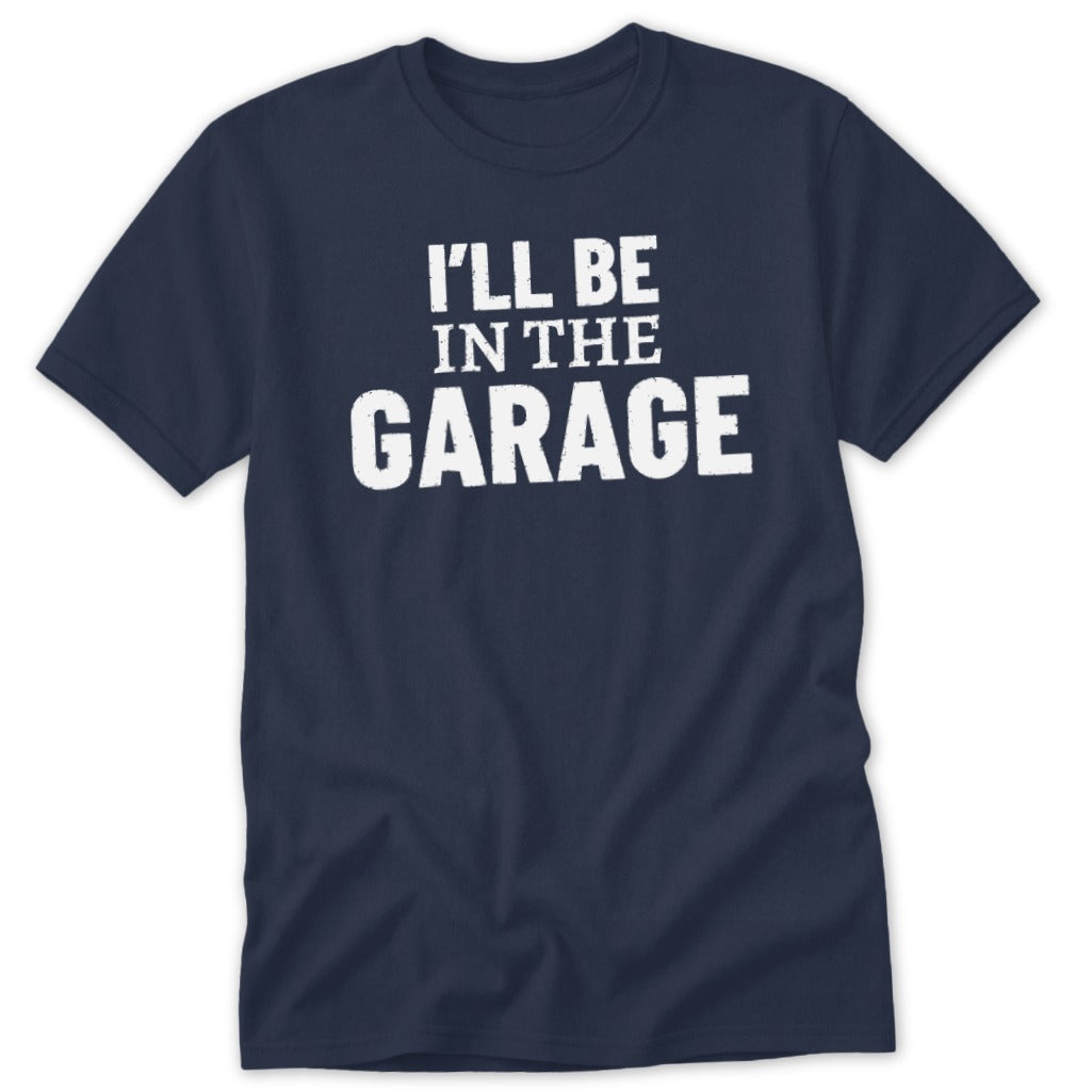Navy t-shirt with white distressed text that reads "I'LL BE IN THE GARAGE".