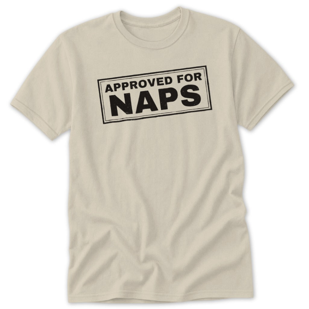 Light beige short-sleeve t-shirt with a rectangular black stamp graphic reading "APPROVED FOR NAPS" on the chest.