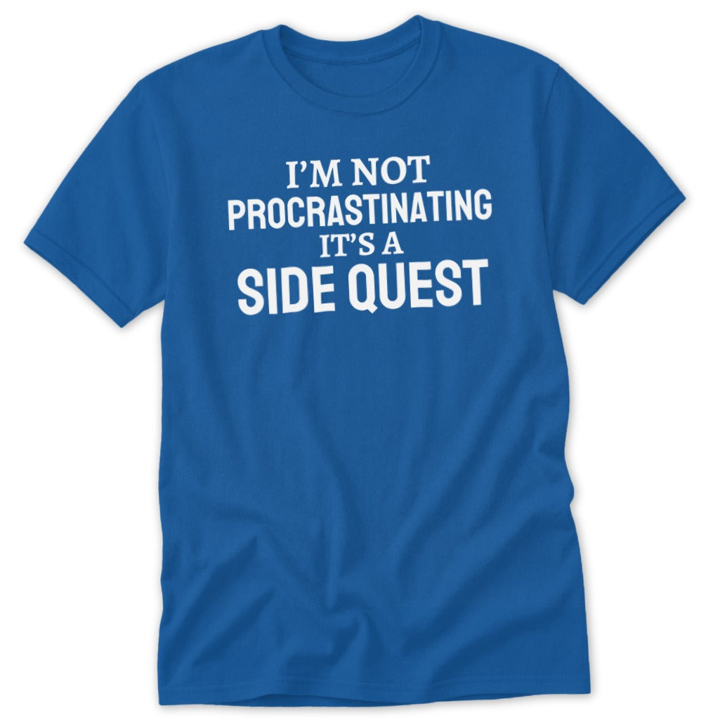 Blue t-shirt with white text: "I'M NOT PROCRASTINATING IT'S A SIDE QUEST".