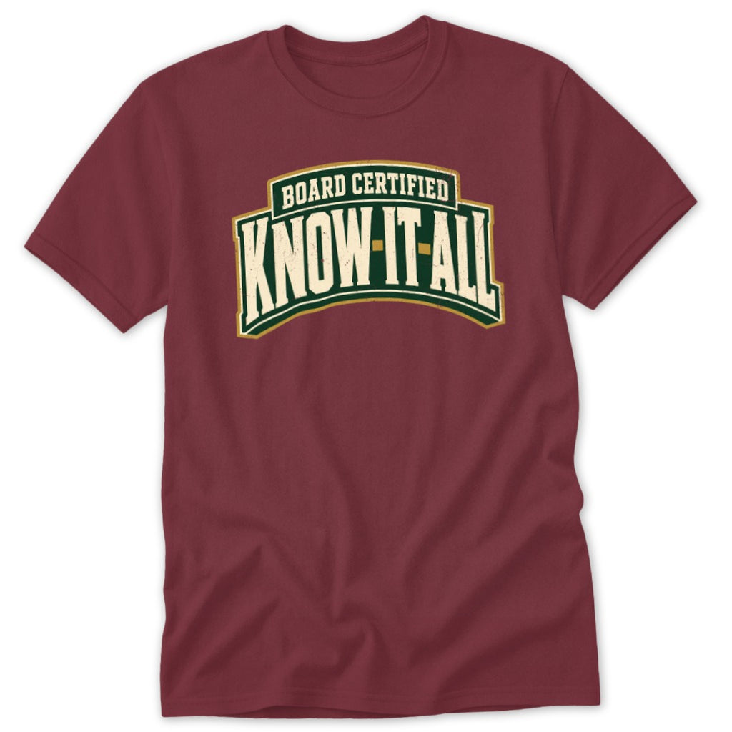 Maroon crewneck t-shirt featuring a green, white, and gold crest with the text BOARD CERTIFIED KNOW IT ALL.