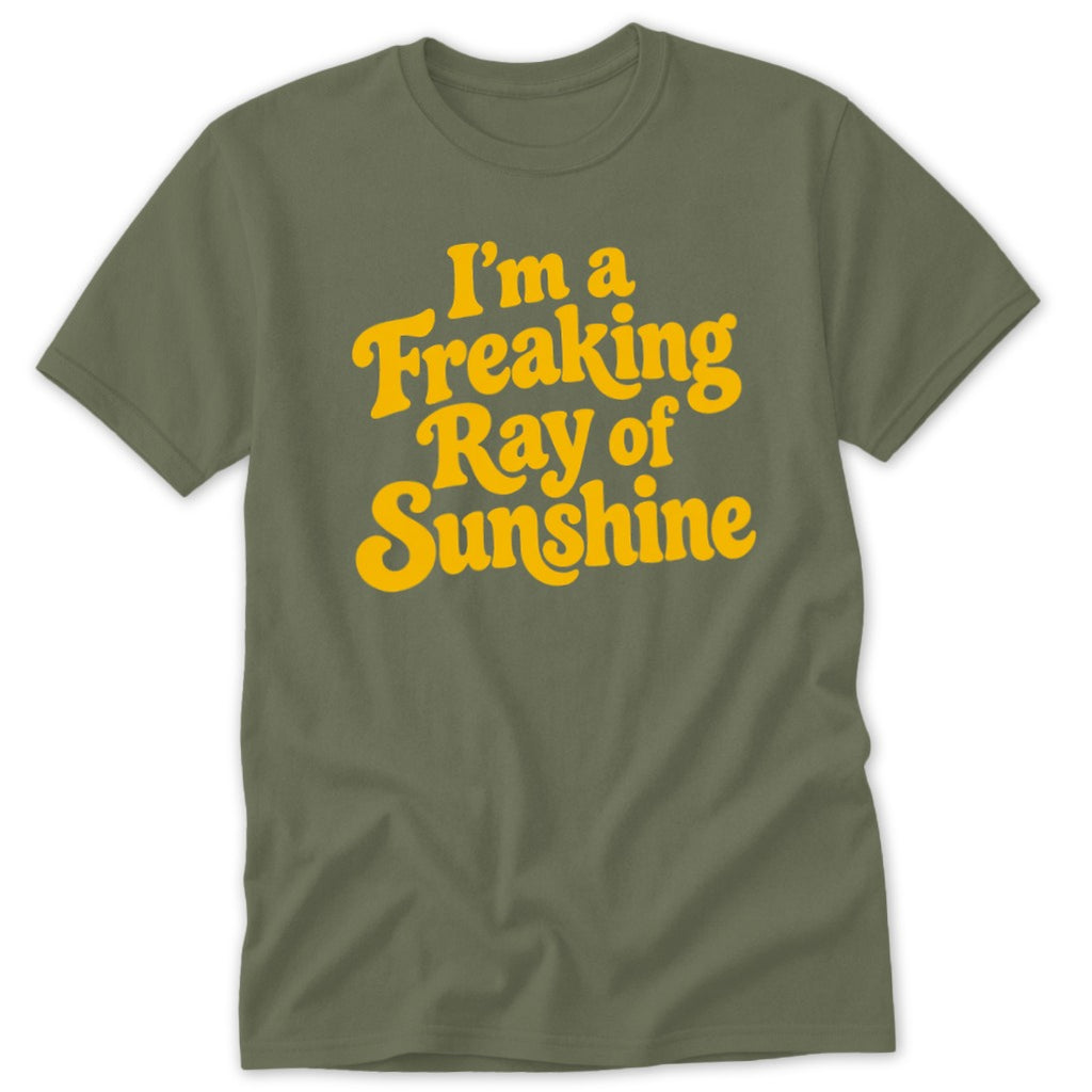 An olive green crewneck t-shirt with yellow text reading I am a Freaking Ray of Sunshine.