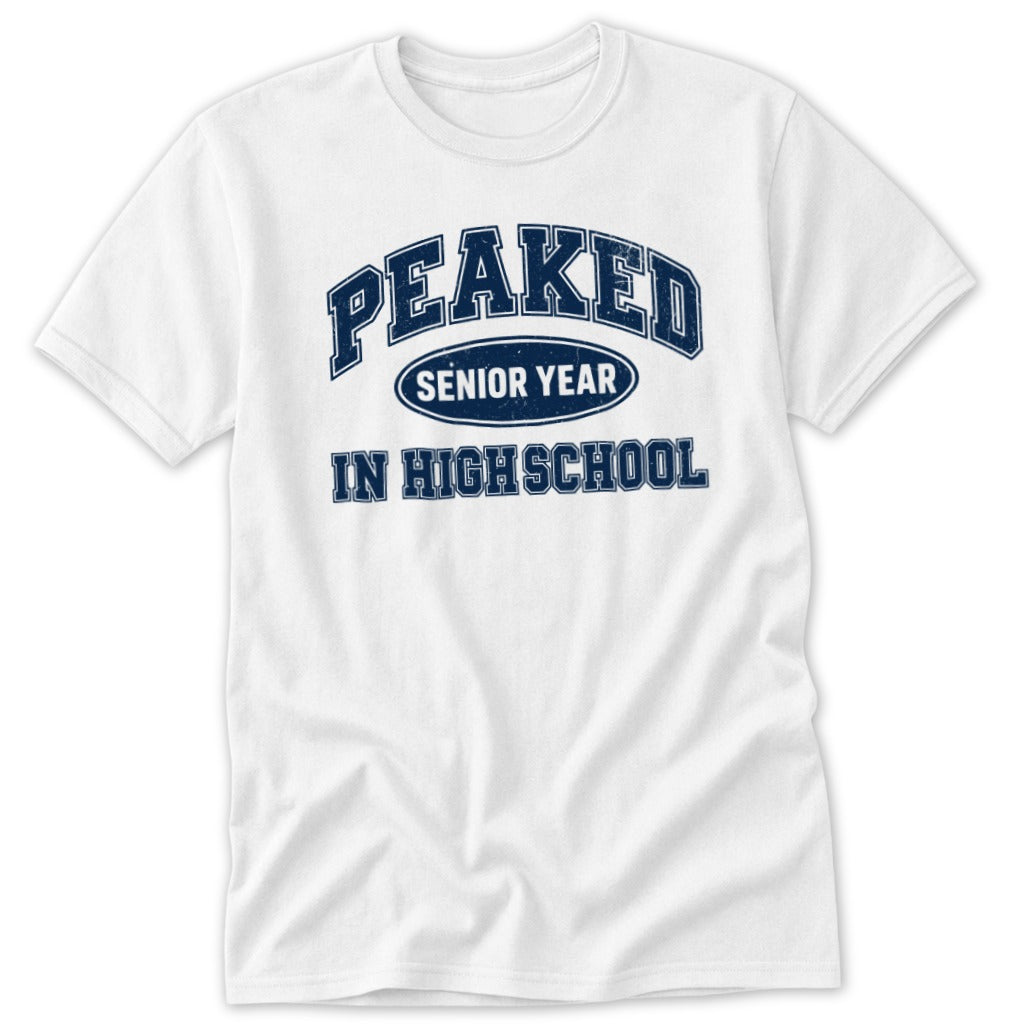 White t-shirt with navy blue text reading "PEAKED SENIOR YEAR IN HIGH SCHOOL".