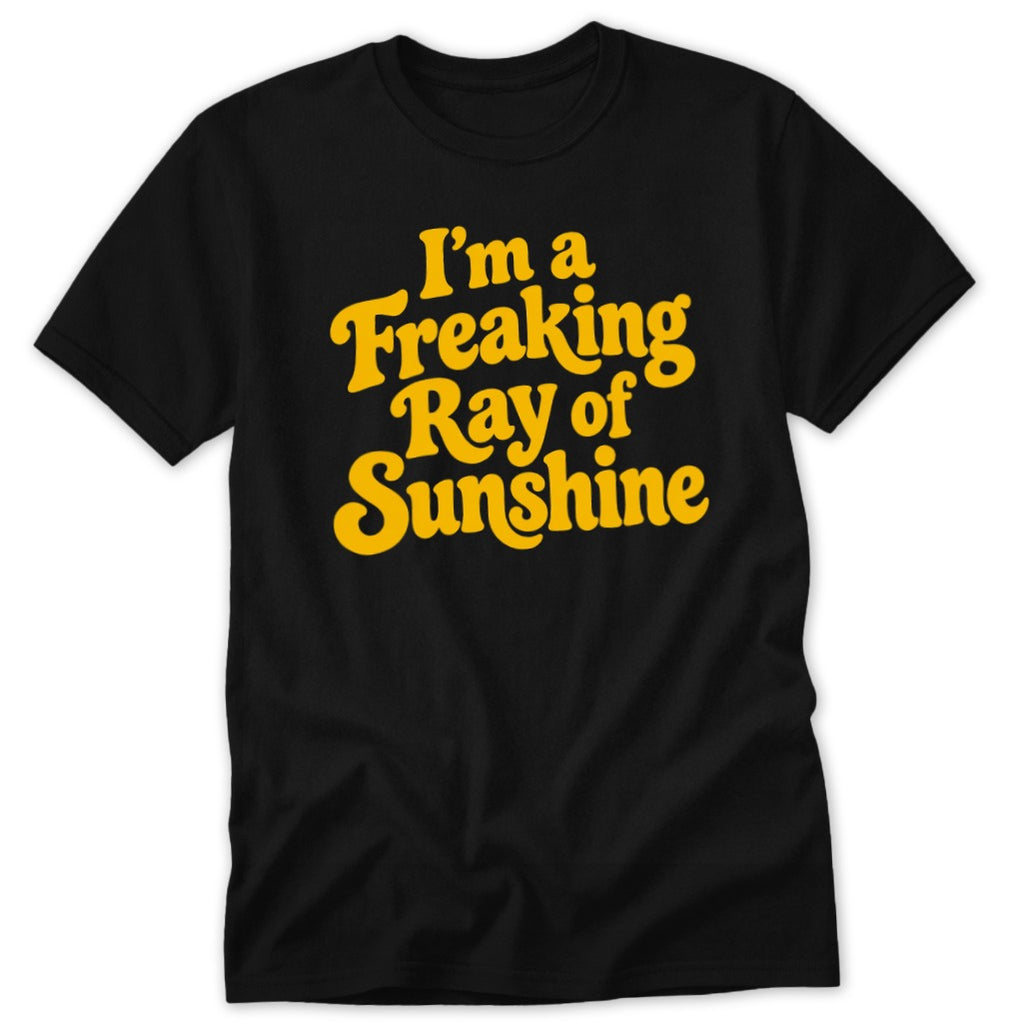 A black short-sleeve t-shirt with yellow text reading I'm a Freaking Ray of Sunshine.