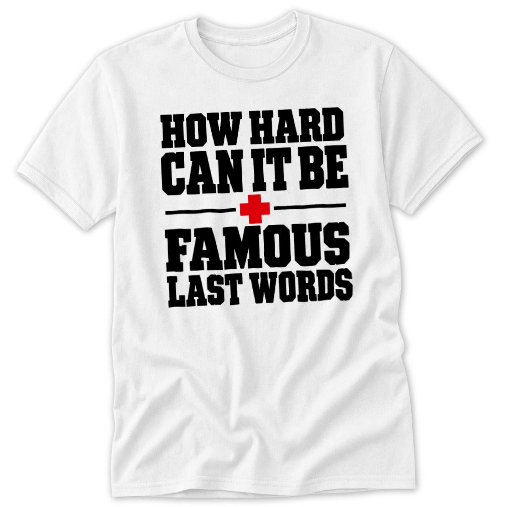 A white short-sleeve t-shirt with black and red text reading How hard can it be, a red cross, and Famous Last Words.