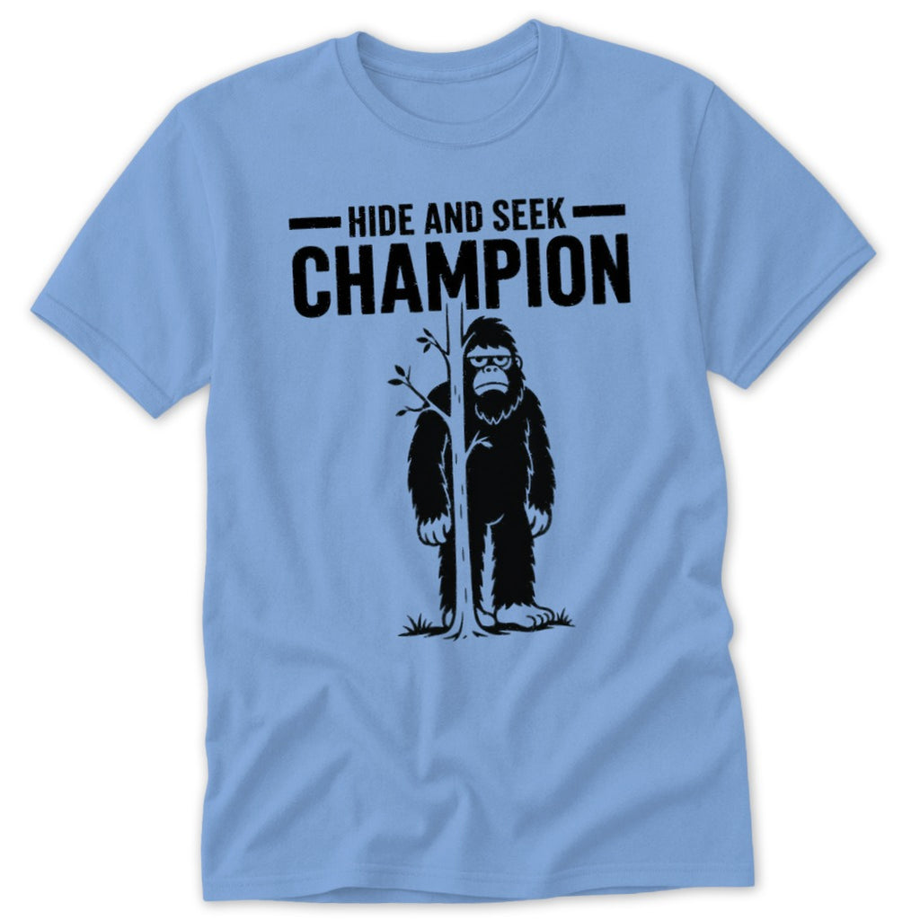 Light blue t-shirt with Bigfoot behind a tree, text "Hide and Seek Champion".