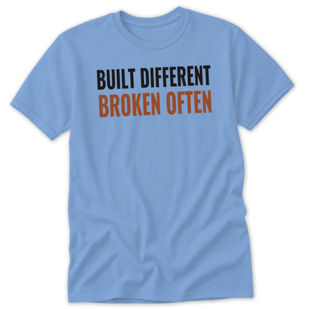 Light blue t-shirt with "BUILT DIFFERENT BROKEN OFTEN" text.