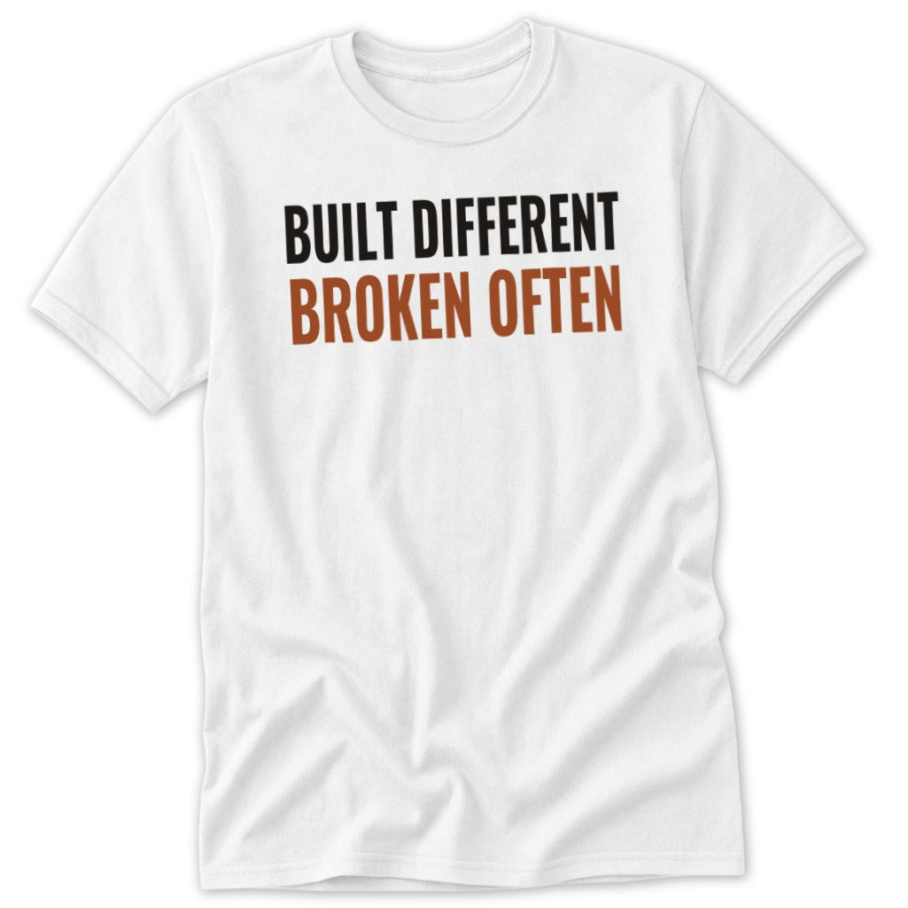 White t-shirt with "BUILT DIFFERENT BROKEN OFTEN" text.
