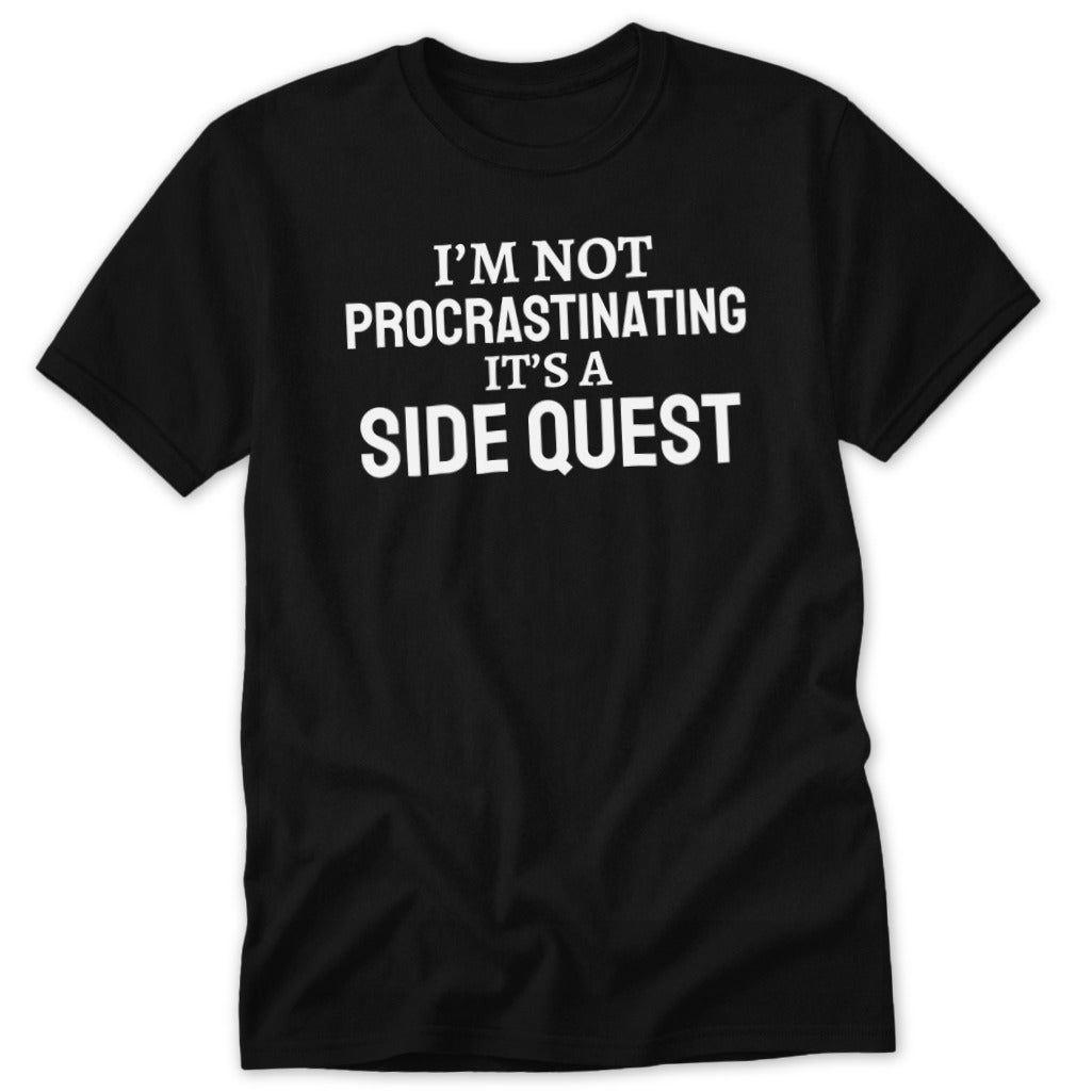 Black t-shirt with white text reading "I'M NOT PROCRASTINATING IT'S A SIDE QUEST".