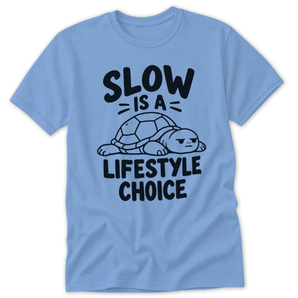 Light blue crewneck t-shirt featuring a resting turtle graphic and black text that reads Slow Is A Lifestyle Choice.